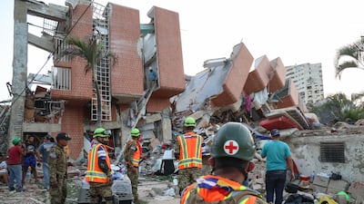 Rescuers from El Salvador search for people trapped in the rubble of a building in Catia La Mar, La Guaira, after two deadly earthquakes struck Venezuela. Getty Images