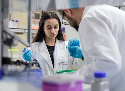 Abu Dhabi, United Arab Emirates, March 7, 2019. Alia Al Mansoori gets trained on proper laboratory procedures by NYUAD Research Assistant Professor, Mohamed Al Sayegh. Victor Besa/The National Section: NA Reporter: Dan Sanderson