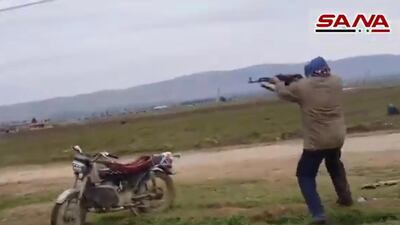 A handout image grab obtained from the official Syrian Arab News Agency (SANA) on February 12, 2020, allegedly shows a man opening fire against US military vehicles in the town of Kherbit Amo near the northeastern Syrian city of Qamishly. The US-led coalition said its forces in northeast Syria today confronted gunmen with live fire after one of its patrols came under attack near the city of Qamishli. According to the coalition forces spokesman Myles Caggins, the patrol encountered a checkpoint occupied by pro-Syrian regime forces and came under small arms fire from unknown individuals and in self defense the coalition troops returned fire. - == RESTRICTED TO EDITORIAL USE - MANDATORY CREDIT "AFP PHOTO / HO / SANA" - NO MARKETING NO ADVERTISING CAMPAIGNS - DISTRIBUTED AS A SERVICE TO CLIENTS == / AFP / SANA / STRINGER / == RESTRICTED TO EDITORIAL USE - MANDATORY CREDIT "AFP PHOTO / HO / SANA" - NO MARKETING NO ADVERTISING CAMPAIGNS - DISTRIBUTED AS A SERVICE TO CLIENTS ==