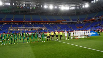 Players line up for the national anthems.