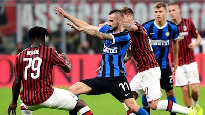 Inter Milan's Croatian defender Marcelo Brozovic challenges AC Milan's Ivorian midfielder Franck Kessie. AFP