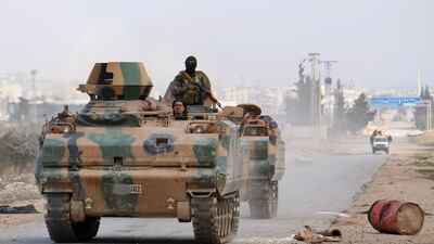 Turkey-backed Syrian opposition fighters advance in an armoured personnel carrier on the western outskirts of Al Bab on February 9, 2017. Saleh Abo Ghaloun / AFP