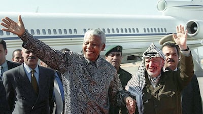 October 19, 1999: Palestinian Authority president Yasser Arafat and the former president of South Africa Nelson Mandela wave to a cheering crowd during their meeting at Gaza international airport. AFP Photo