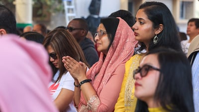 Praying outside St Joseph's on Christmas Day. Victor Besa / The National