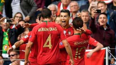 Ronaldo is congratulated by his teammates. AP Photo