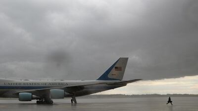An Air Force One crew member runs towards the base terminal for shelter as a storm approaches following a flight from Maine, at Joint Base Andrews in Maryland, US. Reuters