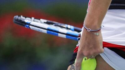 Karolina Pliskova, of the Czech Republic, tucks a ball under her skirt before serving to Angelique Kerber. Julio Cortez / AP Photo