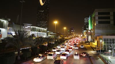 Cars pass by the kingdom tower Sunday, June 14, 2015, in Riyadh, Saudi Arabia. Saudi Arabia's $585 billion stock market is opening up to direct foreign investment for the first time in its history on June 15. (AP Photo/Hasan Jamali)