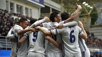 Real Madrid’s James Rodriguez, second right, celebrates after scoring his team’s third goal. Alvaro Barrientos / AP Photo