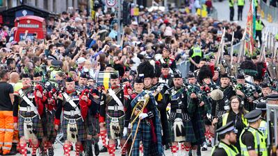 The Combined Cadet Force Pipes and Drums and the Cadet Military Band proceed down the Royal Mile. Reuters