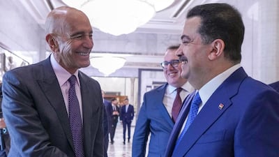 Iraq's Prime Minister Mohammed Shia Al Sudani, right, receives US Special Envoy to Iraq Tom Barrack before attending the signing of agreements between Chevron Corporation and the Basra, Dhi Qar, and North Oil Companies. AFP