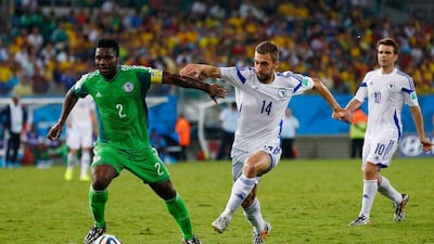 Joseph Yobo of Nigeria and Tino-Sven Susic of Bosnia fight for the ball during their match on Saturday at the 2014 World Cup in Cuiaba, Brazil. Matthew Lewis / Getty Images