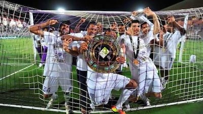 Al Ain players celebrate after lifting the Pro League trophy. Anas Kanni / Al Ittihad