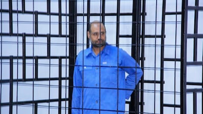 Saif Al Islam Qaddafi, son of late Libyan leader Muammar Qaddafi, attends a hearing behind bars in a courtroom in Zintan. Reuters