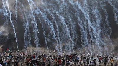Israeli army soldiers fire tear-gas at Palestinians protesters during clashes after Friday protests near the border with Israel in eastern Gaza City. Mohammed Saber / EPA