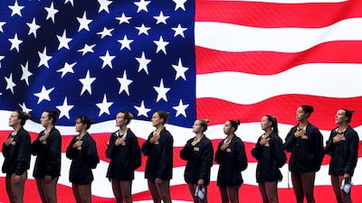 US athletes stand for the national anthem before the Women's Water Polo match against China on day one of the Singapore 2025 World Aquatics Championships. Getty Images
