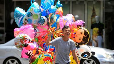 A boy walks with balloons for sale in Sidon, southern Lebanon. Reuters