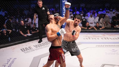 Khotam Boynazarov (grey shorts) retained his UAE Warriors welterweight belt with unanimous decision over James Llontop. Photo: UAE Warriors