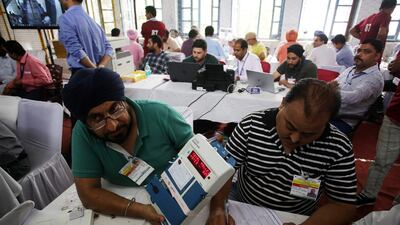 An election official in Jammu display the tally from an electronic voting machine. EPA