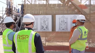 Officials scan etchings of deities that will carved on the pillars of the Hindu temple being constructed in Abu Dhabi.