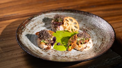 Grilled scallops with a Japanese herb sauce and fresh black truffle is part of Zuma Abu Dhabi's 10th anniversary tasting menu. Photo: Zuma