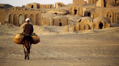 A man rides a donkey in the Christian Cemetery of Al Bagawat. Egypt is establishing a hotel development fund aiming at providing capital to financially impaired hotels to conduct necessary investments. Getty Images