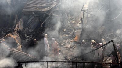 Firefighters work to extinguish a blaze that engulfed a market selling spare car parts in Kandahar, Afghanistan. EPA