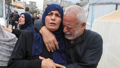 Umm Ibrahim Abu Mahadi, consoled by her brother, mourns at the funeral of her six children killed on April 13 by an Israeli air strike in Deir Al Balah, Gaza. Reuters