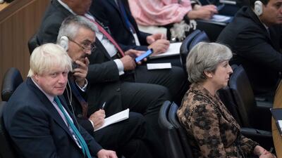 British foreign secretary Boris Johnson, left, sits behind prime minister Theresa May during a high-level meeting at United Nations headquarters in New York on September 20, 2017. Mary Altaffer / AP Photo