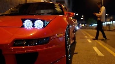 Modified racing cars line up in a Hong Kong backstreet before a race in the early hours of the morning.
