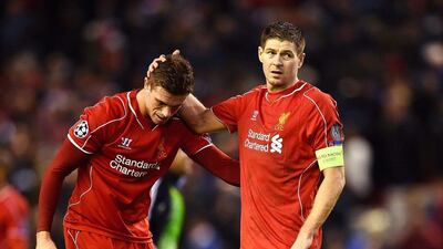 Liverpool players Jordan Henderson, left, and Steven Gerrard react following their team's 1-1 draw with FC Basel at Anfield on Tuesday night, which left them third in Group B in the Champions League and eliminated from the competition. Laurence Griffiths / Getty Images / December 9, 2014