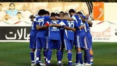 Al Nasr football team gather at Ajman stadium yesterday before the start of their first match since the death of their player Salem Saad.