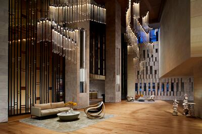 A glass chandelier hangs from the hotel lobby ceiling. Photo: Ritz-Carlton