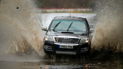 Motorists drive along a flooded road in Ironbridge. Getty Images