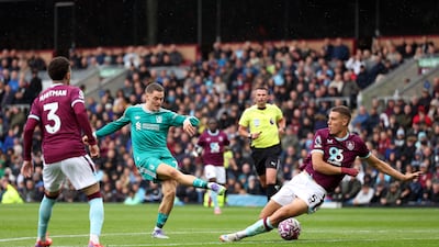 Liverpool's Florian Wirtz shoots for under as Maxime Esteve of Burnley attempts to block. Getty Images