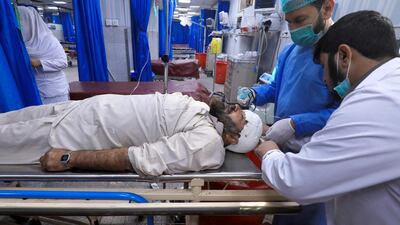 Medics give first aid to a person who was injured during a bomb blast at a religious seminary, at a hospital in Peshawar, Pakistan. REUTERS