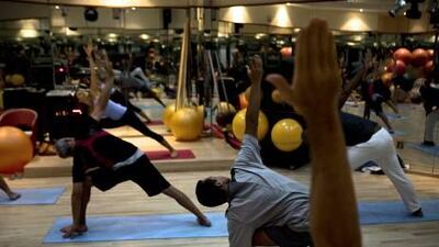 Men workout in an all-male yoga class in the UAE.