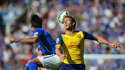 Nacho Monreal of Arsenal wins a header with Leonardo Ulloa of Leicester City during their Premier League match on Sunday. Michael Regan / Getty Images