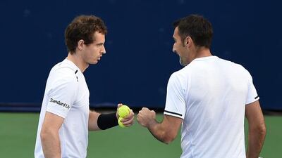 Andy Murray of United Kingdom and Nenad Zimonjic of Serbia discuss tactics during their doubles match against Dan Evans and Gilles Muller. Tom Dulat / Getty Images
