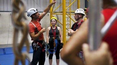 Professional caver Philippe Bence, centre, explains cave rigging and rescue techniques.