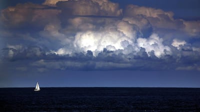A storm cloud can be seen behind a yacht as it sails off the coast of Sydney. The Bureau of Meteorology last week forecast ‘warmer and drier than usual’ weather extending well into winter for Sydney and most of south-eastern Australia over the next three months. David Gray / Reuters