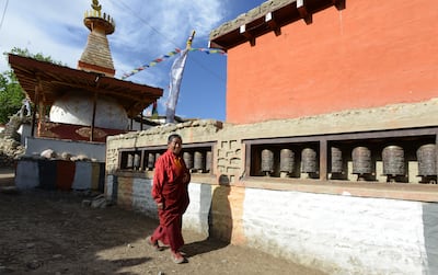 A Nepalese monk walks past a stupa (chorten) at Ghemi village in Lo Manthang in Upper Mustang. AFP