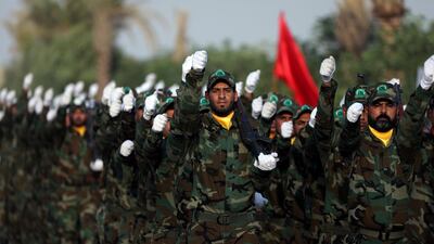 Members of the paramilitary Popular Mobilisation Forces take part in their graduation ceremony at a military camp in Karbala last month. Reuters