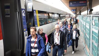 The ticket winners for the first train through the Gotthard tunnel get ready to board. Urs Flueeler / EPA