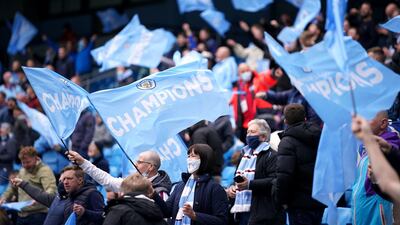 Manchester City fans wave flags during the match against Everton at the Etihad Stadium. PA