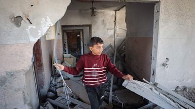 A Palestinian child walks through the rubble of a house hit by overnight Israeli bombing in Rafah, in the southern Gaza Strip, on Saturday. AFP