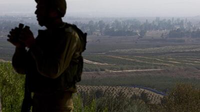 An Israeli soldier observes Syria's Quneitra province at an observation point on Mount Bental in the Israeli-controlled Golan Heights, overlooking the border with Syria on September 1, 2014. Al Qaeda-linked Syria rebels who are holding more than 40 United Nations peacekeepers hostage in the Golan Heights have set their demands for the release of their Fijian hostages. Sebastian Scheiner/AP Photo