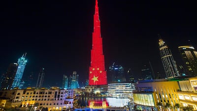 The Burj Khalifa is lit up in the colours of the Chinese flag on Tuesday morning. Leslie Pableo / The National