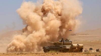 Smoke billows as Iraqi government forces supported by fighters from the Abbas Brigade, which fights under the umbrella of the Shiite popular mobilisation units, advance towards the city of Tal Afar, the remaining stronghold of ISIL, after the government announced the beginning of an operation to retake it from the extremists on August 20, 2017. Mohammed Sawaf/AFP Photo