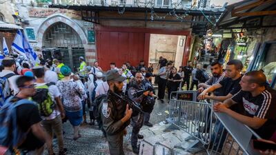 Israeli border and riot police separate Palestinians from thousands of marching Israelis who pass through the Muslim Quarter of Jerusalem's Old City. EPA